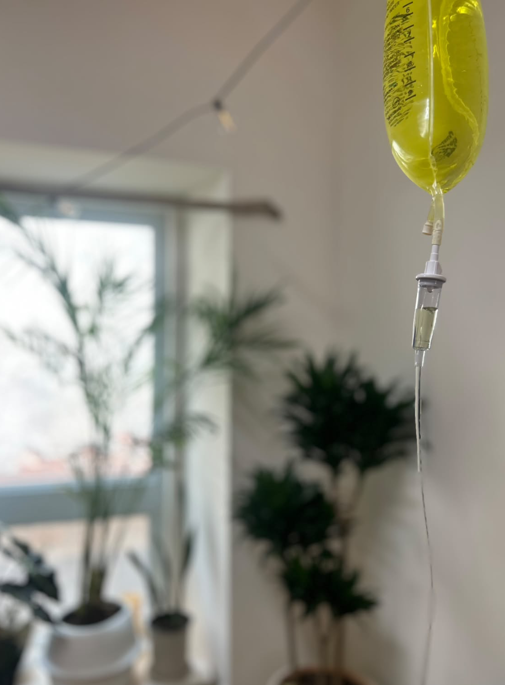 Close-up of an IV drip with the calming clinic in the background